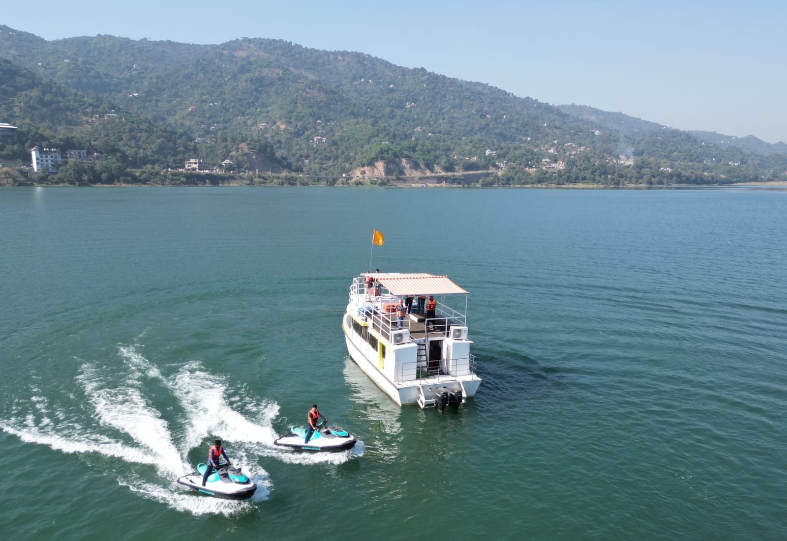 Luxury cruise and two jet skis operating on the Satluj River in Bilaspur