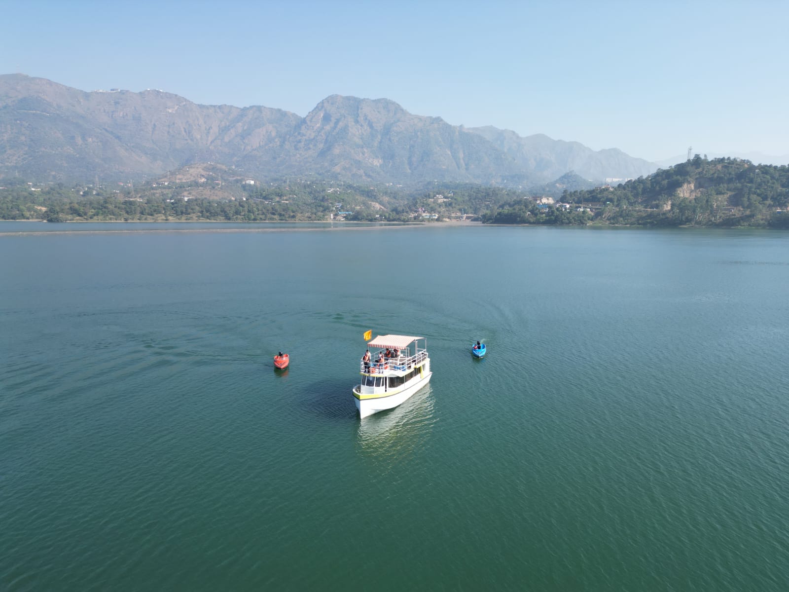 Aerial view of the cruise and watercraft surrounded by Bilaspur hills