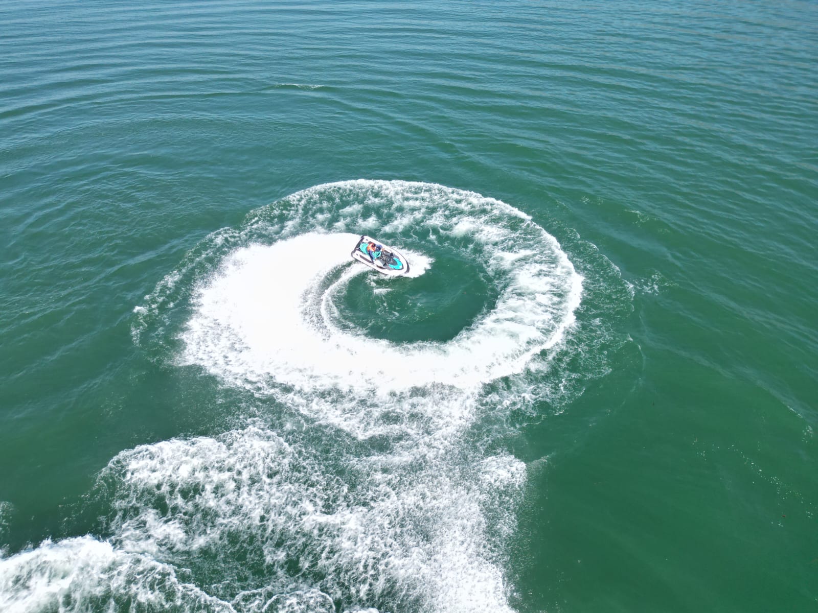 Jet ski creating a circular wake on the Satluj River
